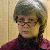 Karen Lewis Serious woman with glasses and short salt-and-pepper hair